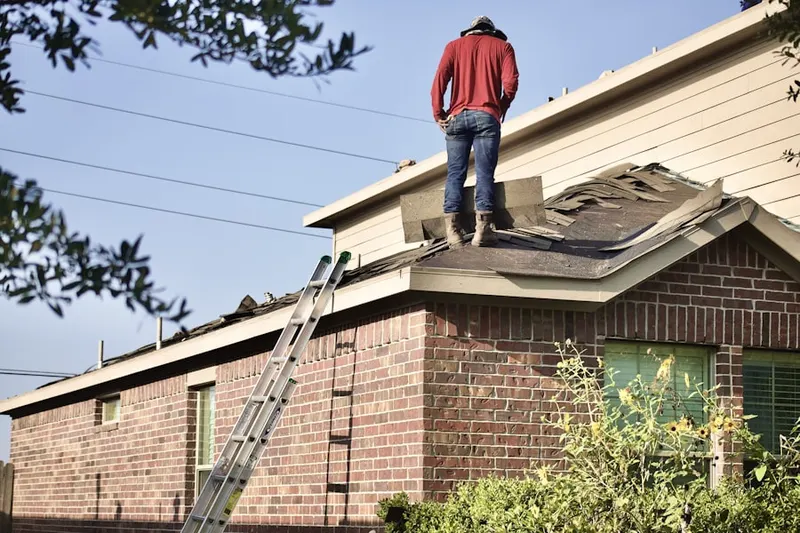 Professional roofer working on a residential roof in Woodbine